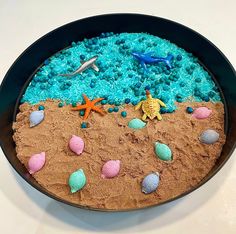 there is a cake made to look like the ocean with sand and seashells