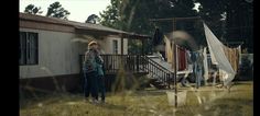 a woman standing in front of a mobile home