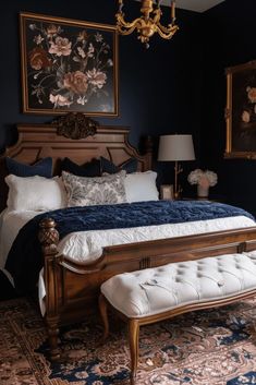 a bedroom with a bed, bench and paintings on the wall