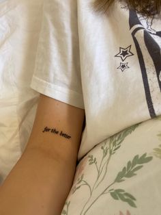 a woman with a tattoo on her arm that reads, for the better you are