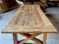 a wooden table sitting inside of a warehouse