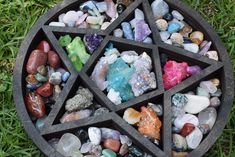 a pentagram surrounded by rocks and stones on the grass