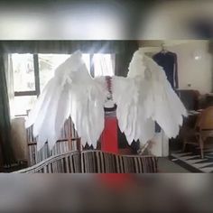 two white angel wings sitting on top of a couch