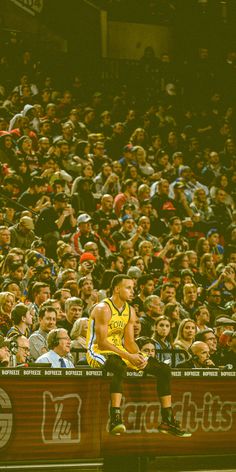 a man standing on top of a basketball court in front of a large group of people