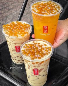 three cups filled with different kinds of food on top of a tray next to each other