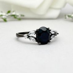 This beautiful ring is made from genuine 925 sterling silver with Black rhodium plating. Ring details- -The Main stone is an oval cut 8mm by 6mm Natural Black Onyx -Side stones are 4mm by 2mm clear Marquise and 1.3mm Round simulated diamonds -Ring is casted in solid 925 sterling silver with black rhodium plating (White rhodium, yellow gold and rose gold plated also available, please check the drop down menu for more options) -The Total face height of the ring measures 8mms and the band width mea Angeles, Xoxo Jewelry, Black Engagement Ring, Cute Engagement Rings, Floral Engagement Ring, White Opal Ring, Wedding Rings Round, Sterling Silver Promise Rings, Black Wedding Rings