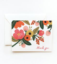 a thank you card with colorful flowers and leaves on it, next to a white envelope