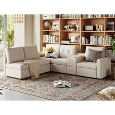 a living room scene with focus on the sectional sofa and bookshelf in the background