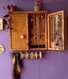 "This is a jewelry organizer / cabinet designed and crafted by me. Functional with an artistic flare is my goal when making functional pieces. Something you can use every day and be well-pleased to display in your bedroom or elsewhere as a piece of art. Designed on TEAK STAIN color, is meant to hold most of your jewelry in a way you can reach them easily. The main body has stainless bars and hooks for earrings of any length, a ring box for more than 10 rings , and a shelf for sunglasses, lotion