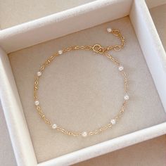 * DETAILS* This dainty bracelet is a perfect gift to the one you love or to yourself. A nice every day bracelet. - Swarovski Crystal Pearl Beads 3mm - 24k Gold Filled Chain - 14K GOLD FILLED Wire - 14k Gold Filled Spring Ring Clasp ✨ All components are 14k Gold Filled. 👉🏻For more pearl bracelets, see https://www.etsy.com/shop/JinnysJewelryBySeJin 🌟You may also like Blue Topaz Bracelet. Here is the link. https://www.etsy.com/JinnysJewelryBySeJin/listing/1088450006/london-blue-topaz-14k-gold-fi Affordable Round Pearl Bracelet For Birthday, Swarovski Bracelet Gold, Gold Bracelet With Pearls, Elegant Adjustable Gold Bracelet For Birthday Gift, Elegant Adjustable Gold Bracelet For Birthday, Elegant Gold Bracelet For Mother's Day Gift, Elegant Chain Bracelet For Anniversary And Mother's Day, Delicate Chain Link Bracelet For Gift, Dainty Charm Bracelet With Delicate Chain As Gift