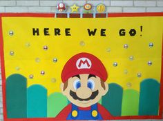 this is a super mario paper cutout on a bulletin board that says here we go