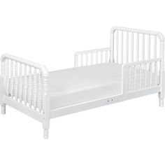 a white toddler bed with no mattress on it