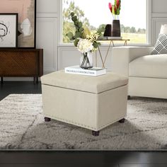 a living room scene with focus on the footstool and coffee table in the center