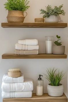 bathroom shelves with towels and plants on them