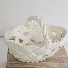 a white bowl sitting on top of a wooden table