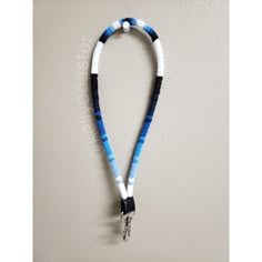 a blue and white lanyard with a metal hook