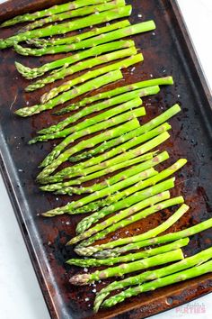 asparagus on a baking sheet ready to be cooked in the oven for dinner