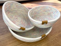 two baskets sitting on top of a wooden table