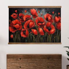 an oil painting of red poppies on a white wall above a dresser with a potted plant