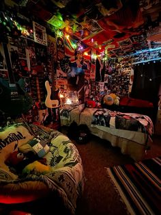 two beds in a room with lights on the ceiling and posters all over the walls