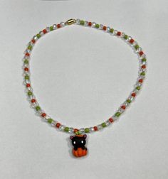 Fun, colorful and easy to lock clasp! My Halloween necklaces are finished with magnetic clasps that makes them that much faster and easier to wear. made with a mix of  glass and acrylic beads and charms this cat necklace is perfect for you to wear, or gift this spooky season. Necklace is 16 inches long. Halloween Necklaces, Pumpkin Cat, Cat Bead, Halloween Necklace, Cat Necklace, Acrylic Beads, Halloween Pumpkin, Spooky Season, Halloween Pumpkins