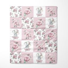 a pink and white floral blanket with an elephant in the center on top of it