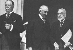 three men standing next to each other in suits