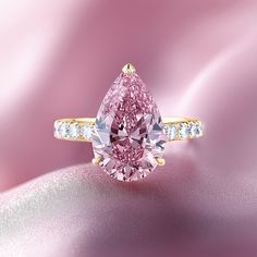 a pink diamond ring with diamonds around it