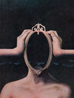 a man is looking into a mirror with his hands on the frame and holding it in front of his face