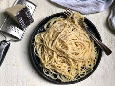 a plate of pasta and graters on a table