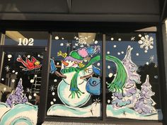 the front window of a store decorated with snowmen and birds