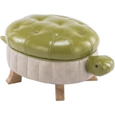 a green turtle ottoman sitting on top of a wooden table