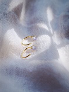 Add the prettiest genuine purple Tanzanite open hoop earrings to sweeten your earlobes. These tiny "claw" hoops are perfect paired with any of our other favorite hoop earrings. ✦ DETAILS ✦✧ Name: Maka'alohi (MA ka a LO hee) - Sparkling eyes.✧ You will receive 1 pair.✧ Size: 10mm outer diameter; 8.5mm inner diameter.✧ Gold Plated Sterling Silver.✧ 3mm Genuine Purple Tanzanite.✧ All Ke Aloha Jewelry pieces come packaged thoughtfully, beautifully, and ready for gift giving. Pierced Hoop Ear Cuff As A Gift, Delicate Hypoallergenic Ear Cuff For Gifts, Hypoallergenic Round Ear Cuff As Gift, Hypoallergenic Round Ear Cuff Gift, Hypoallergenic Ear Cuff Gift, Gift Huggie Ear Climbers With Ear Wire, Pierced Huggie Ear Cuff As Gift, Small Hoop Pierced Cartilage Earrings As Gift, Round Ear Cuff With Matching Earrings As Gift