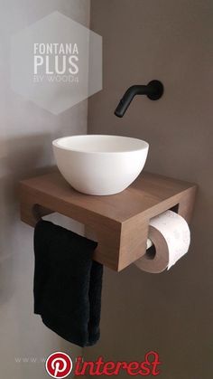 a bathroom with a bowl sink and toilet paper on the shelf next to the wall