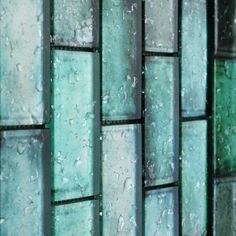 a close up view of some glass blocks with drops of water on the glass surface