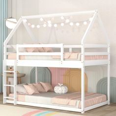 a white bunk bed with pink sheets and pillows on the bottom level is decorated with string lights