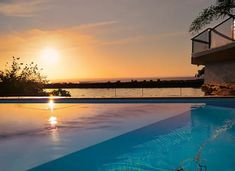 the sun is setting over an empty swimming pool