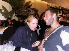 a man and woman sitting at a table in a restaurant