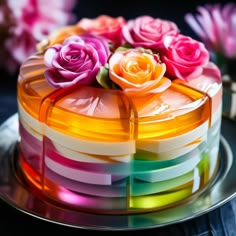 there is a multicolored cake with flowers on it