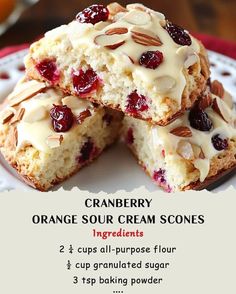 cranberry orange sour cream scones with white icing on a red and white plate