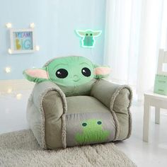 a baby yoda chair in a child's room with lights on the wall