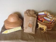 a brown bag sitting on top of a bed next to a stuffed giraffe