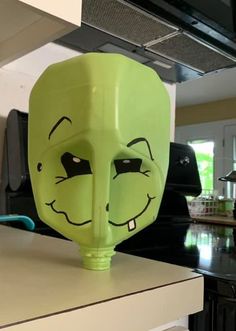 a green mask sitting on top of a kitchen counter