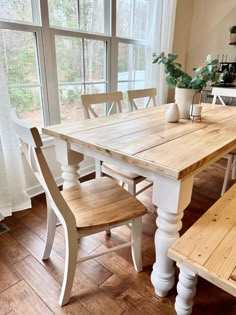 a kitchen table with two benches next to it and a potted plant on top