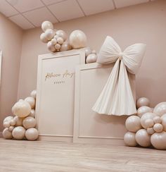 a room with balloons and bows on the wall