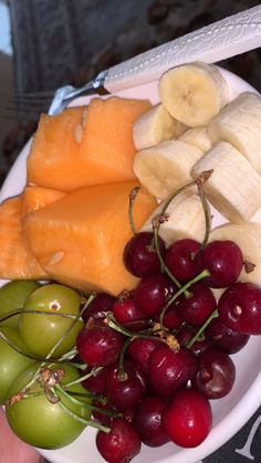 a white plate topped with lots of different types of fruit