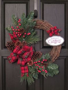 a christmas wreath with pine cones and red berries