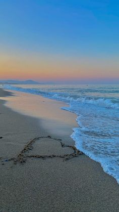 the heart is drawn in the sand on the beach