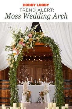 the wedding arch is decorated with flowers and greenery