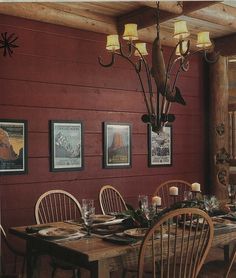 the dining room table is set with place settings for eight people, and there are pictures on the wall behind it